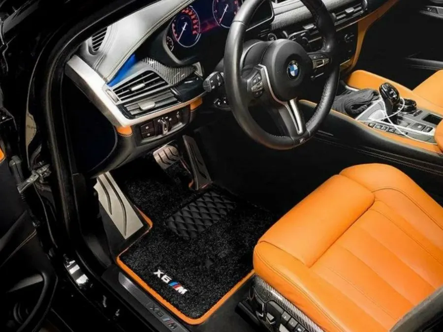 BMW X6 M — black set in an orange cabin, contrast stitching